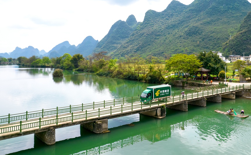 郵車行駛在桂林市陽(yáng)朔縣遇龍河的大橋上