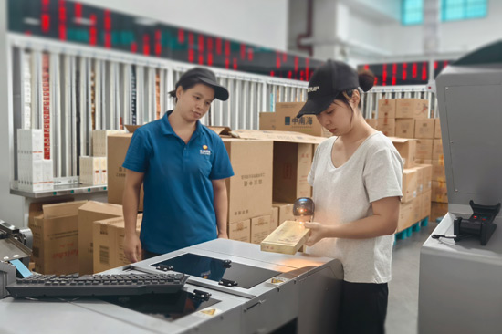 青年員工魯凱容（右）在分享異型煙快捷掃碼分揀技巧—陳美瑛攝